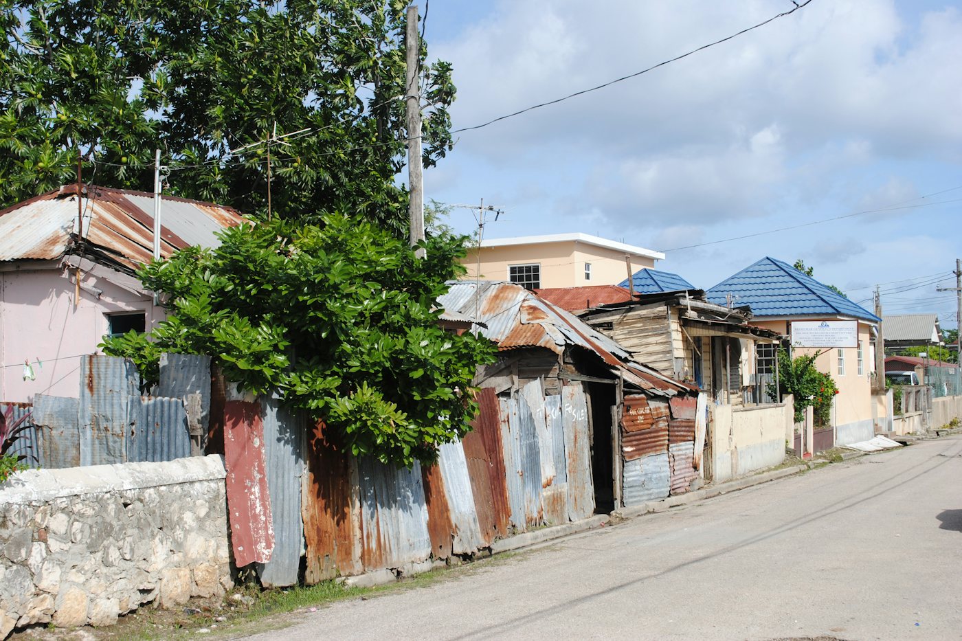Zinc fences and weathered houses along a quiet street in Falmouth, Trelawny, Jamaica